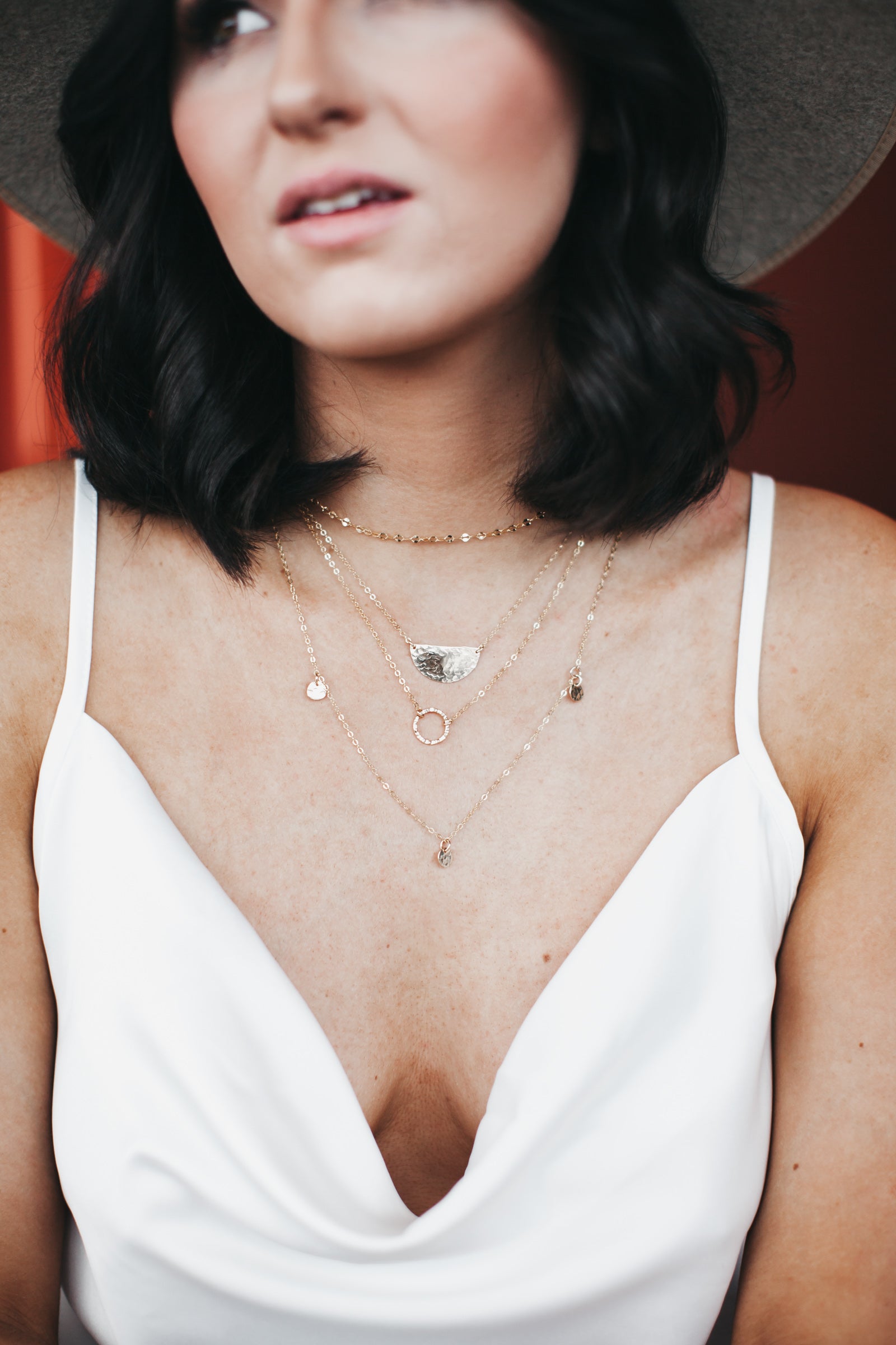 Model wears the layering chain with the half moon necklace and three disc necklace
