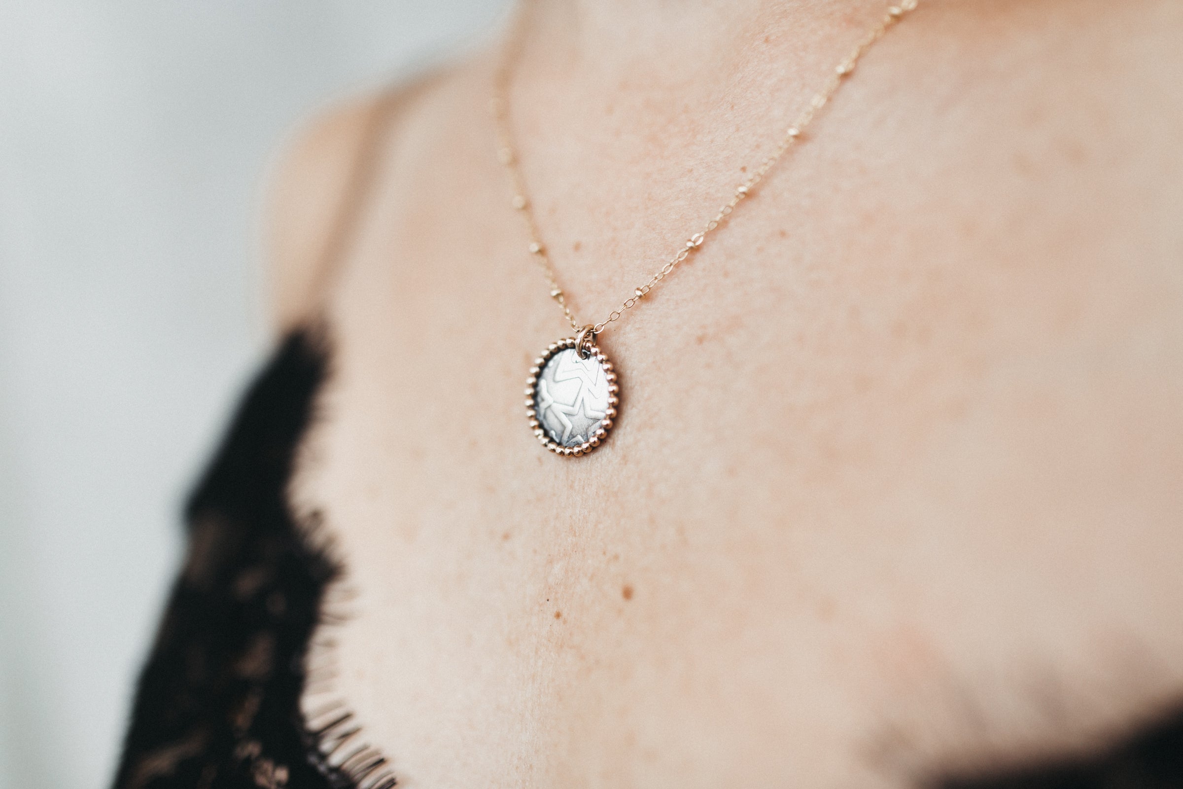 Close up of the Two-tone Sterling Silver coin pendant on a 14k Gold Filled Chain necklace