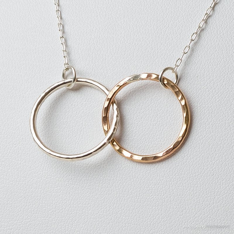 Close up of sterling silver and 14k gold filled interlocking circle necklace