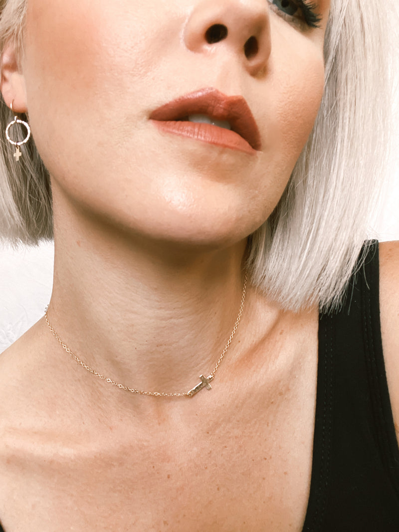 Model wears the Sideways Cross Necklace with Circle Cross earrings