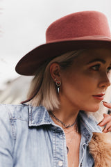 Model wears the Hexagon Spike Studs with Lightning Bolt Stud earrings and layered necklaces