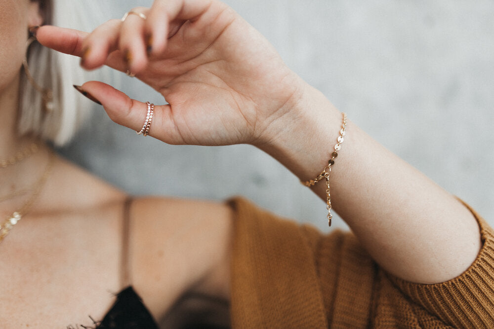 Model wears the Mykonos chain bracelet with the stackable beaded rings