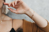 Model wears the Mykonos chain bracelet with the stackable beaded rings