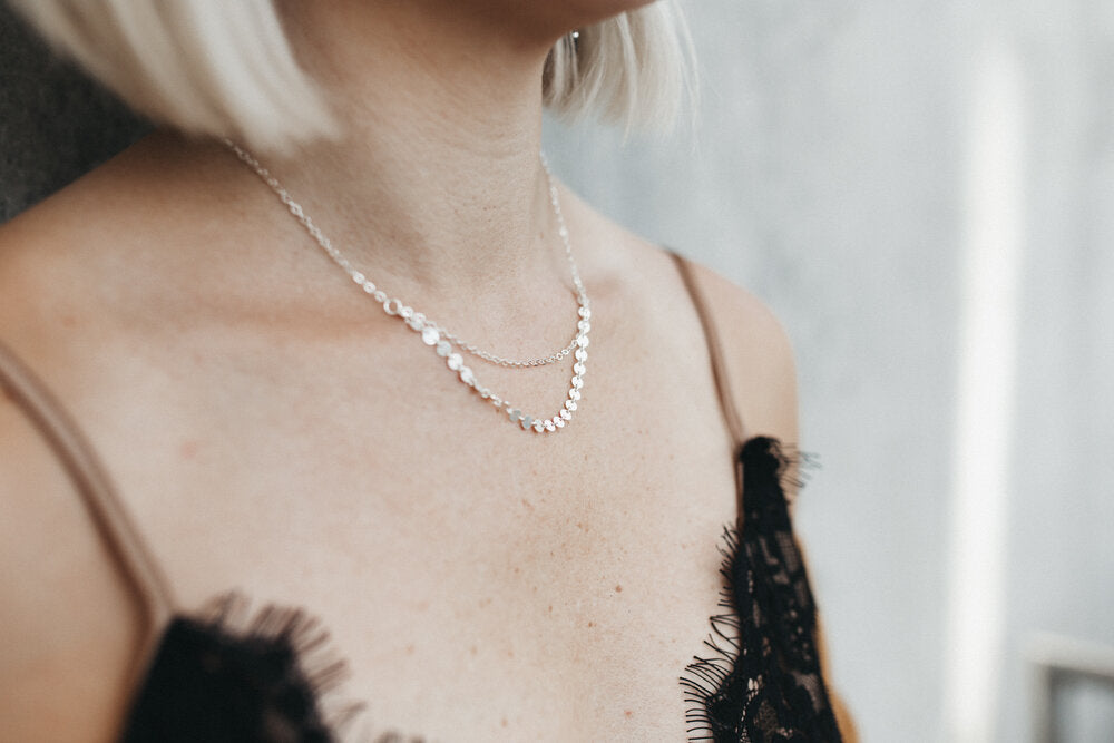 Model styles the Mykonos layering necklace with black lace
