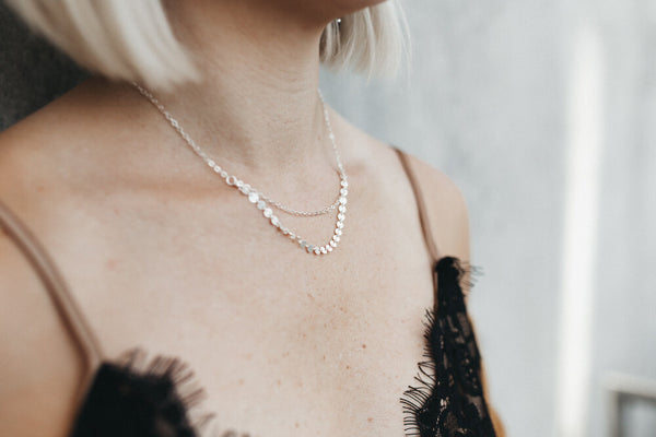 Model styles the Mykonos layering necklace with black lace