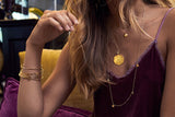 Model layers the Talia Single Disc Pendant Necklace with Medallion necklace and Talia 10 Disc Long Necklace