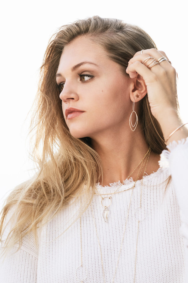 Model wears Two tone marquis earrings with the tiny star studs