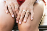 Model wears the Stackable Wave Rings with Oval Ring and Interlocking Rings