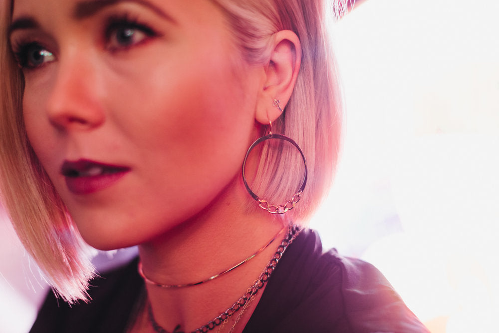 Model wears the Tiny Cross Stud Earrings with Two Tone Blondie Hoops