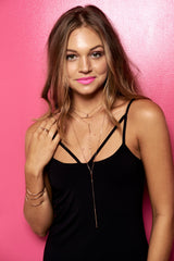 Model wears two Long Bar Lariat Necklaces with wave cuffs
