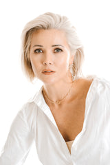 Model wears the Kenda Kist Paper Clip Chain Toggle Necklace with double hoop earrings