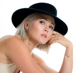 Model wears the Molly Textured Hoop on Post Earring with Chain rings, beaded band rings and faceted cuff bracelet
