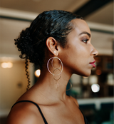Model wears The Sunnies Lightweight Gold Statement Earring with Tiny Star Stud earrings