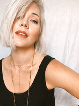 Model wears the two-tone Teardrop necklace with Mykonos long chain necklace