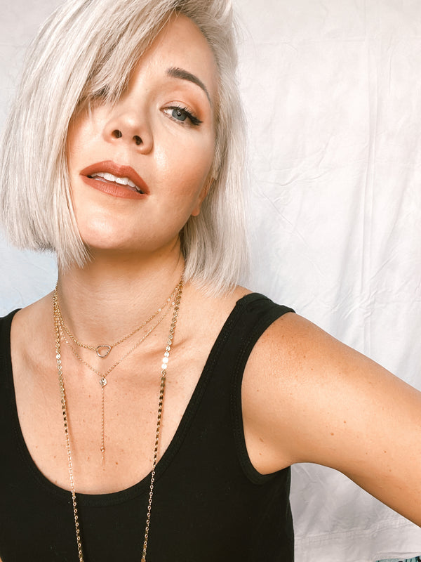 Model wears the two-tone Teardrop necklace with Mykonos long chain necklace