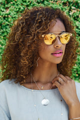 Model wears the Tiny Dancer Swarovski® Crystal Necklace with Medallion Necklace and Star Hoops