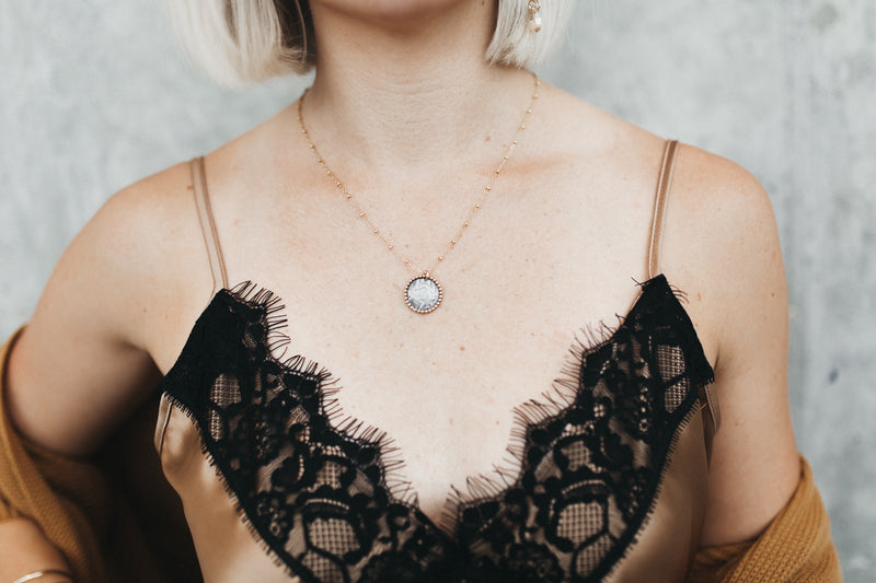 Model wears Two Tone Coin Pendant Necklace by Kenda Kist