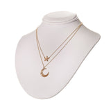 Dainty Star Pendant necklace layered with a Moon Necklace on a neck display