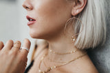 Model wears the Lightning Bolt stud earrings with the Large Circle Crystal Drop earrings