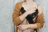 Model styles the Mykonos chain bracelet with the cuff bracelet and wave cuff